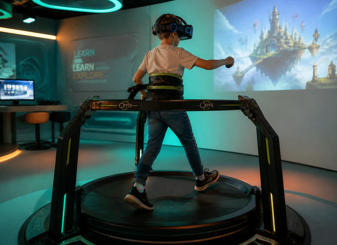 Child on a 360-degree Virtuix-style omnidirectional treadmill wearing a VR headset, immersed in a virtual learning world